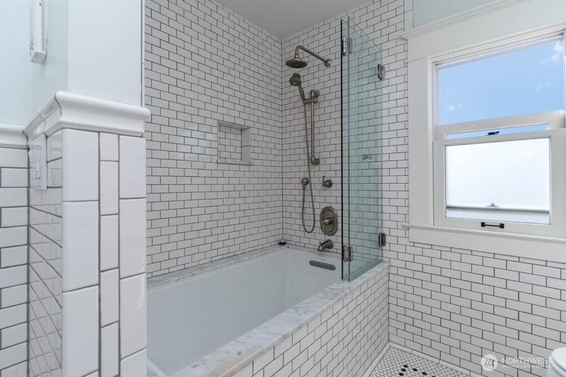 1607 6th Avenue West Seattle, WA 98119 - Photo 14 of 27 a bathroom with a bathtub and shower