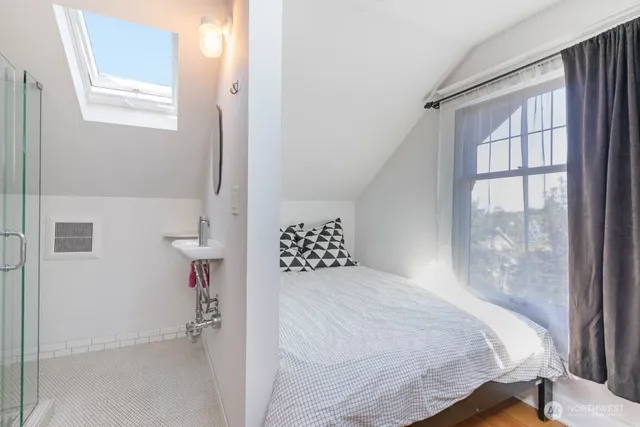 a bedroom with a bed and a window