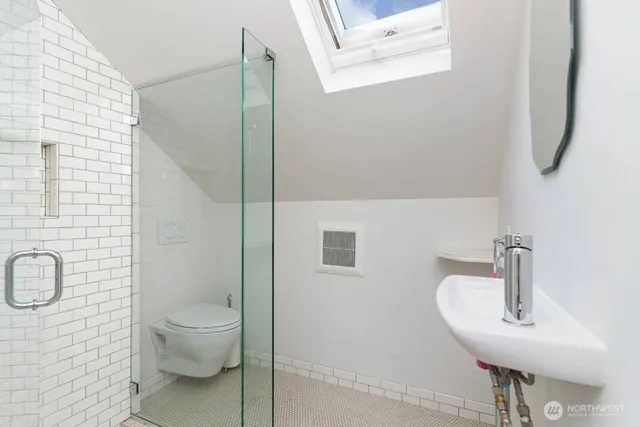 a bathroom with a toilet sink and shower