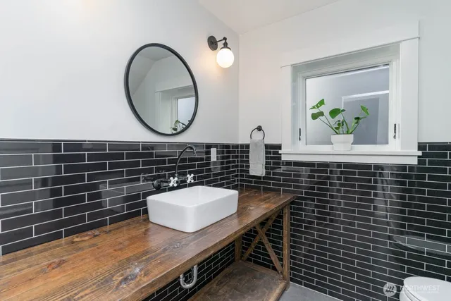 a bathroom with a sink a mirror and a toilet