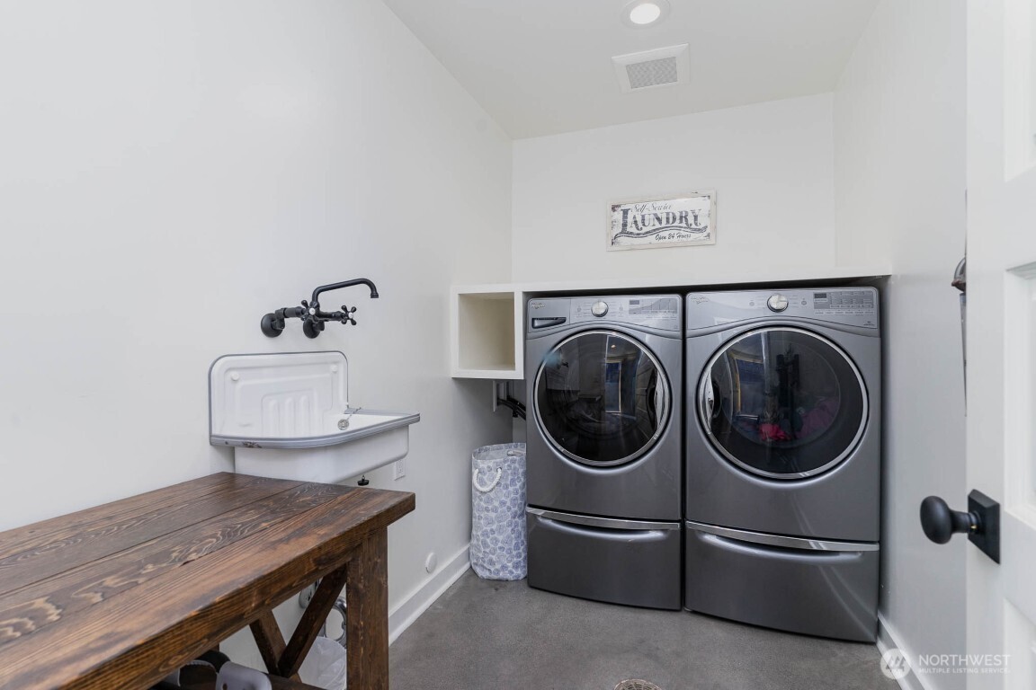 1607 6th Avenue West Seattle, WA 98119 - Photo 24 of 27 a close view of a storage and utility room with a sink