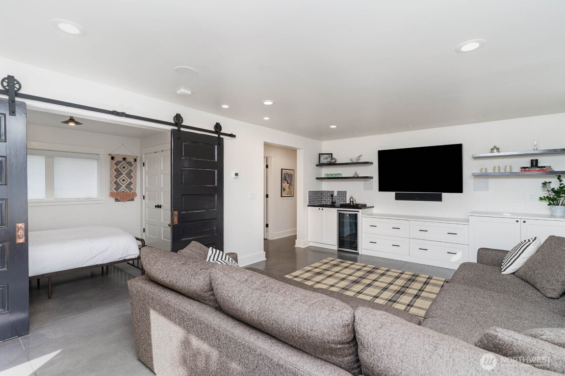 1607 6th Avenue West Seattle, WA 98119 - Photo 25 of 27 a living room with furniture and a flat screen tv