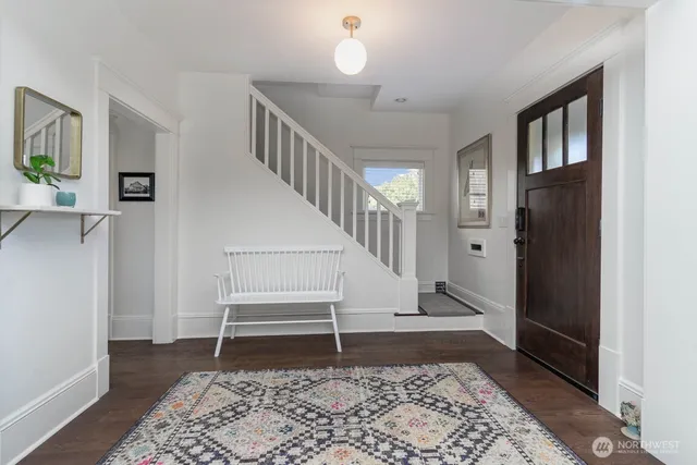 a view of entryway with wooden floor and a rug