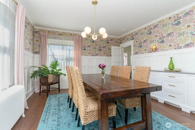a view of a dining room with furniture and a chandelier