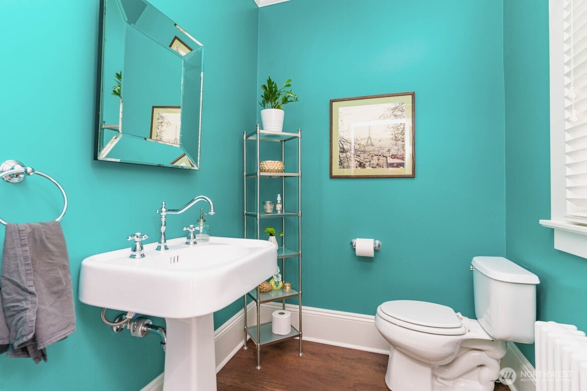 1607 6th Avenue West Seattle, WA 98119 - Photo 9 of 27 a bathroom with a toilet a sink and mirror