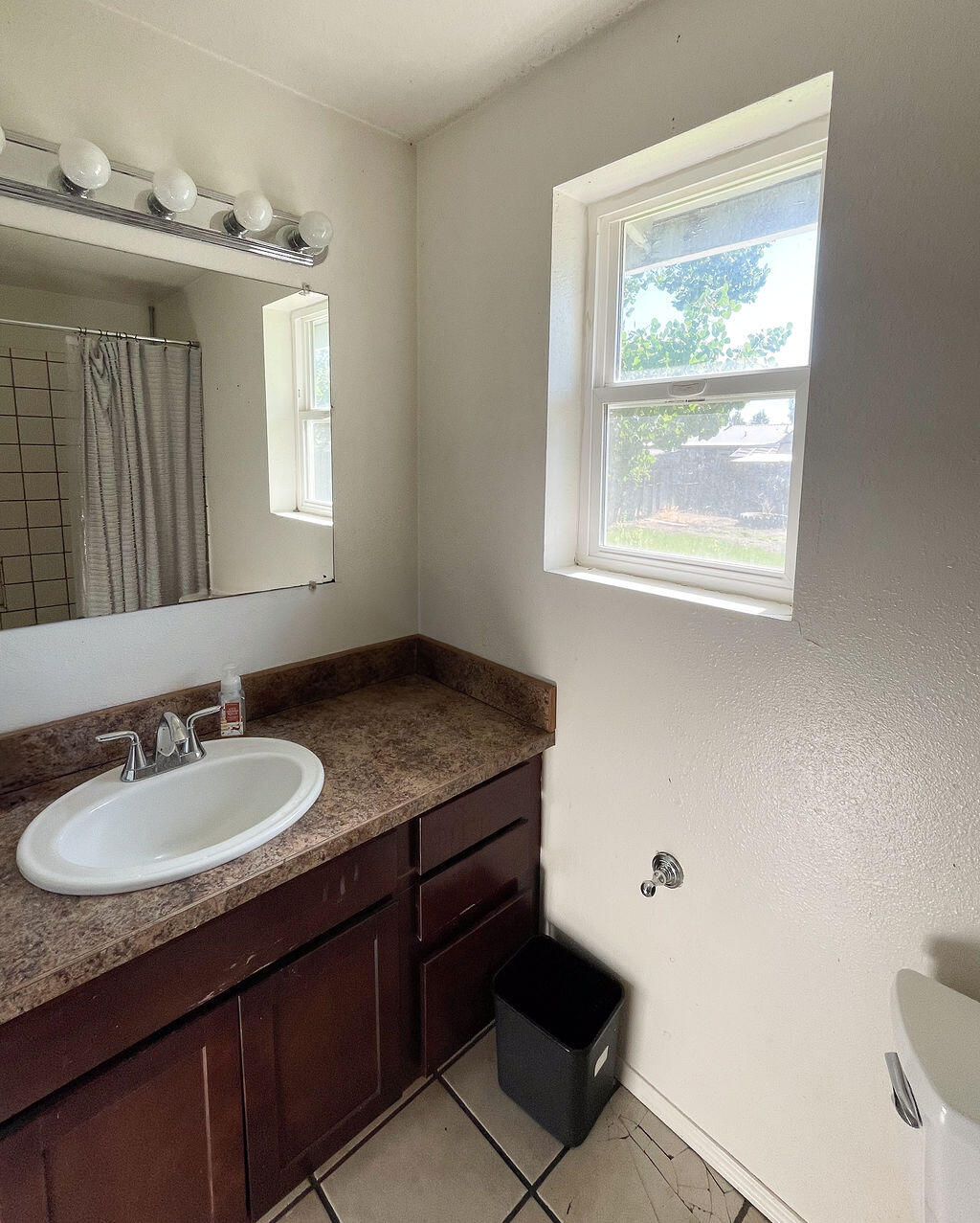3037 Clearbrook Place Malin, OR 97632 - Photo 24 of 30 a bathroom with a granite countertop sink a mirror and a window