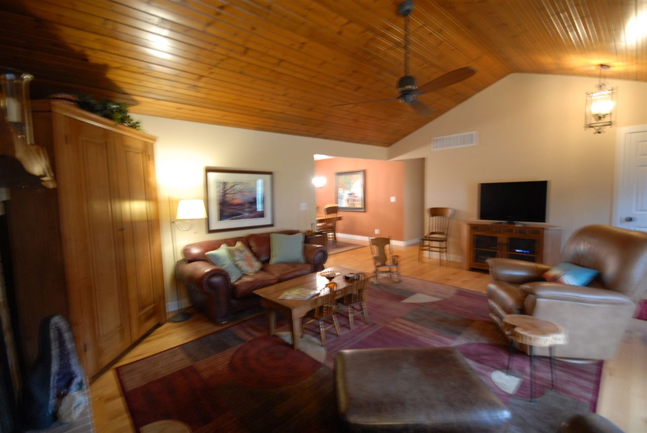 5525 Rural Edge Drive Roscoe, IL 61073 - Photo 11 of 21 a living room with furniture a flat screen tv and kitchen view