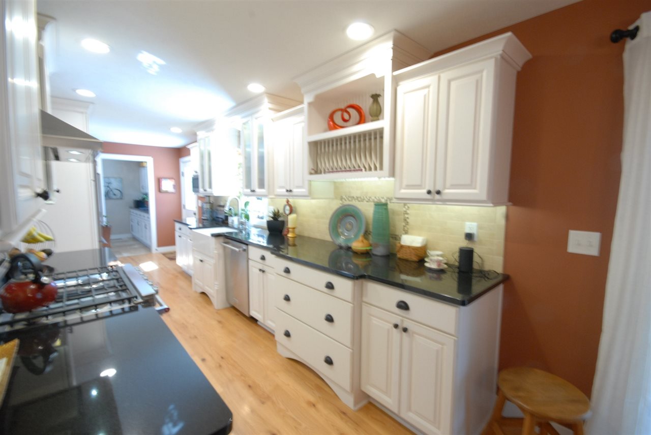 5525 Rural Edge Drive Roscoe, IL 61073 - Photo 8 of 21 a kitchen with granite countertop a sink stove and cabinets