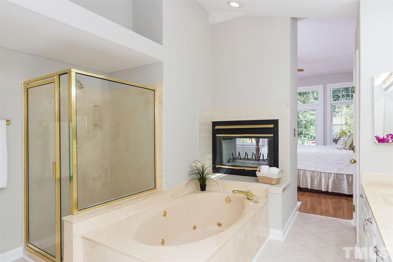 10108 Goodview Court Raleigh, NC 27613 - Photo 14 of 25 a white bath tub sitting in a en suite bathroom next to a window