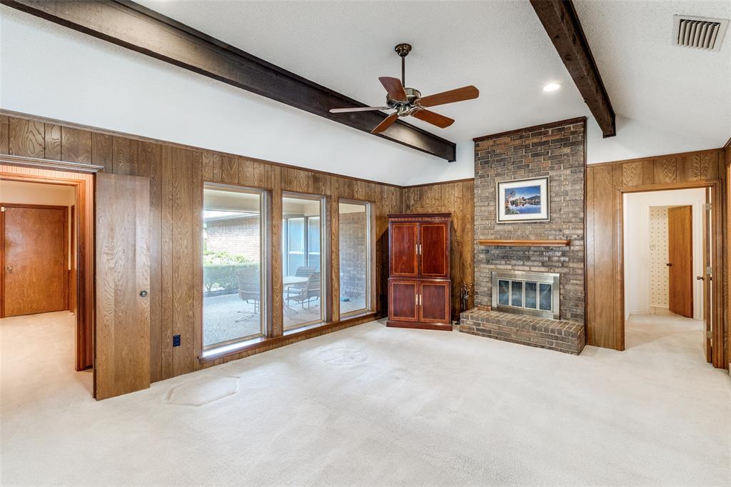 9121 Church Road Dallas, TX 75231 - Photo 2 of 13 a view of a livingroom with a fireplace a ceiling fan wooden floor and hallway