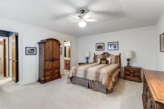 a spacious bedroom with a bed and a chandelier
