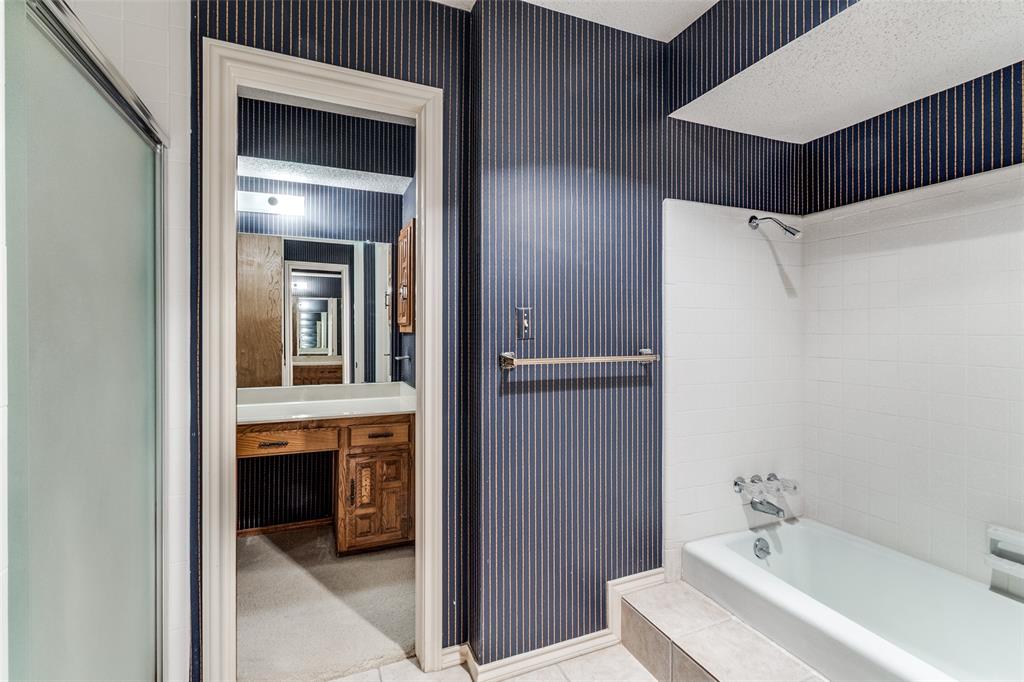 9121 Church Road Dallas, TX 75231 - Photo 6 of 13 a en suite bathroom with a sink and a mirror