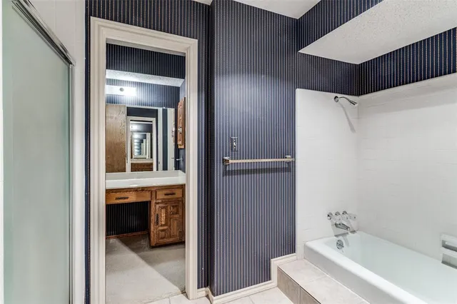 a en suite bathroom with a sink and a mirror