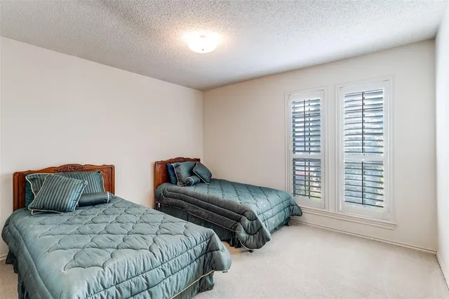 a bedroom with two beds and a window