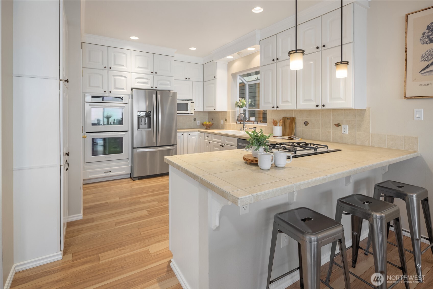 1882 Shore Avenue Freeland, WA 98249 - Photo 12 of 36 a kitchen with kitchen island a stove a table and chairs in it