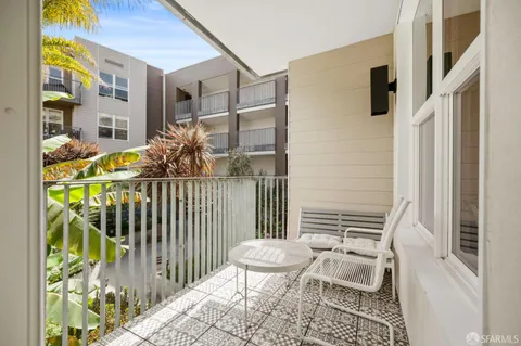 a view of backyard with outdoor seating and trees