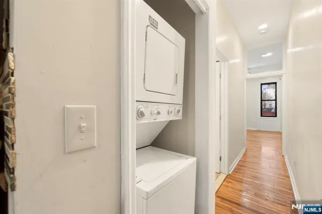a view of a hallway with wooden floor and entryway