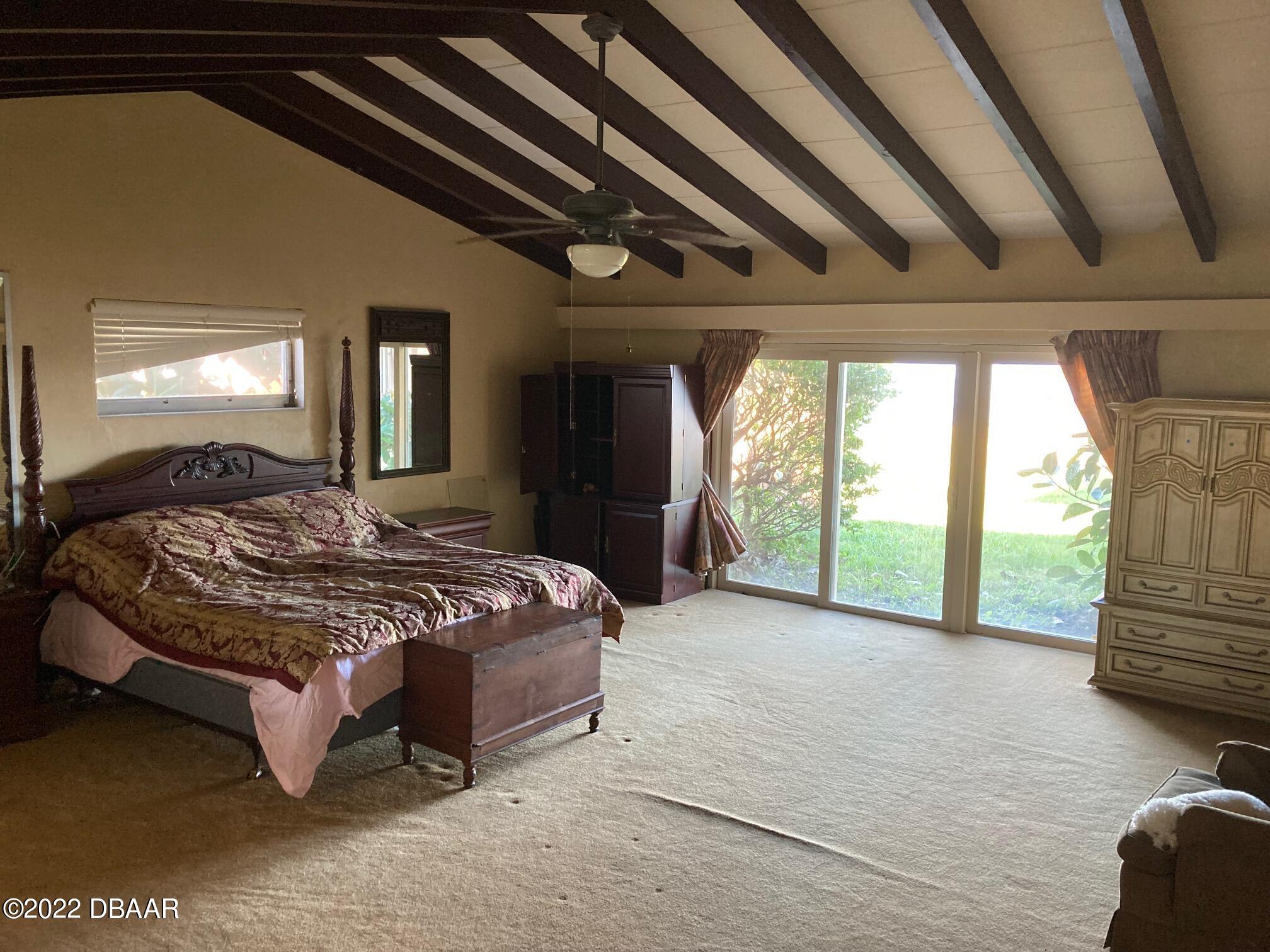132 Reef Road South Daytona, FL 32119 - Photo 10 of 11 a spacious bedroom with a large bed and a large window