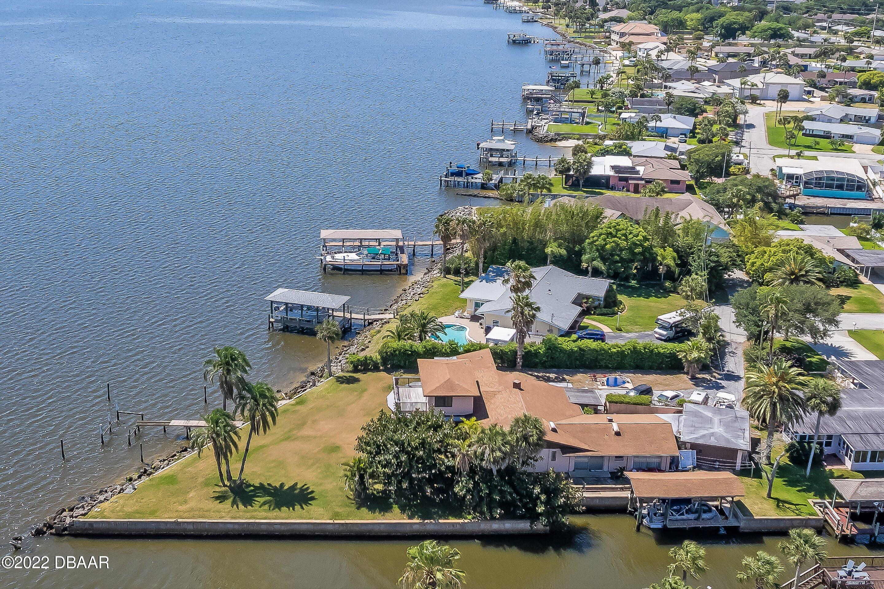 132 Reef Road South Daytona, FL 32119 - Photo 4 of 11 an aerial view of a house with a garden and lake view