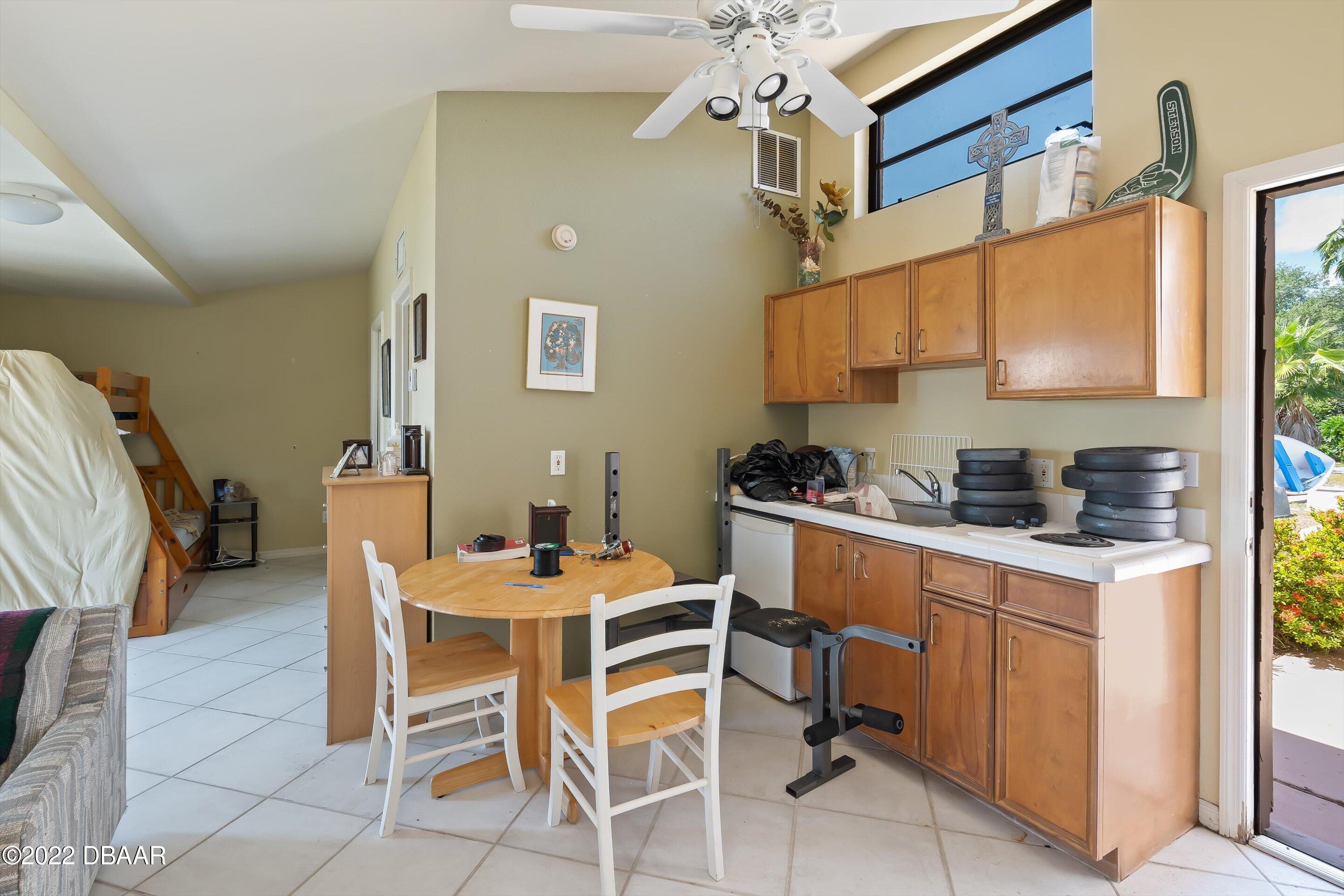 132 Reef Road South Daytona, FL 32119 - Photo 6 of 11 a room with stainless steel appliances kitchen island granite countertop furniture and a dining table