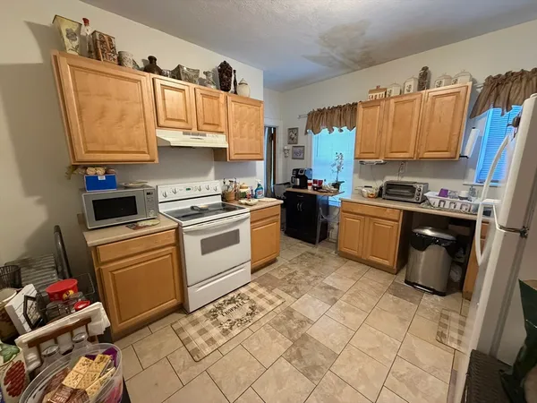 a kitchen with stainless steel appliances granite countertop a sink dishwasher stove top oven and cabinets