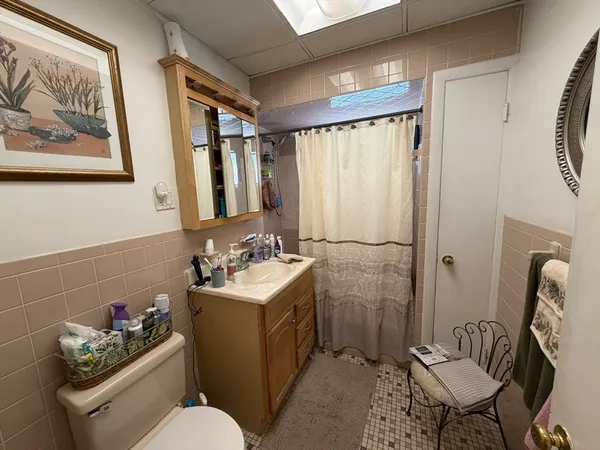 a bathroom with a sink toilet and a mirror
