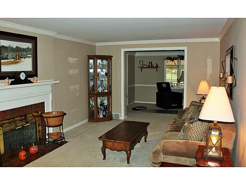131 Orchard Spring Road Pittsburgh, PA 15220 - Photo 4 of 25 Living Room. Living room features crown molding and neutral wall to wall carpeting.