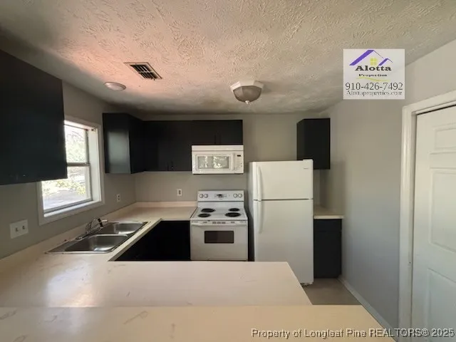 a kitchen with stainless steel appliances a refrigerator and a stove top oven