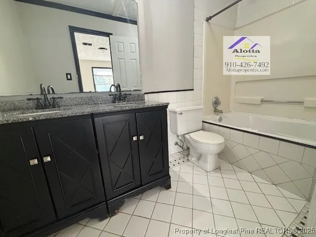 a bathroom with a granite countertop sink a toilet and a mirror