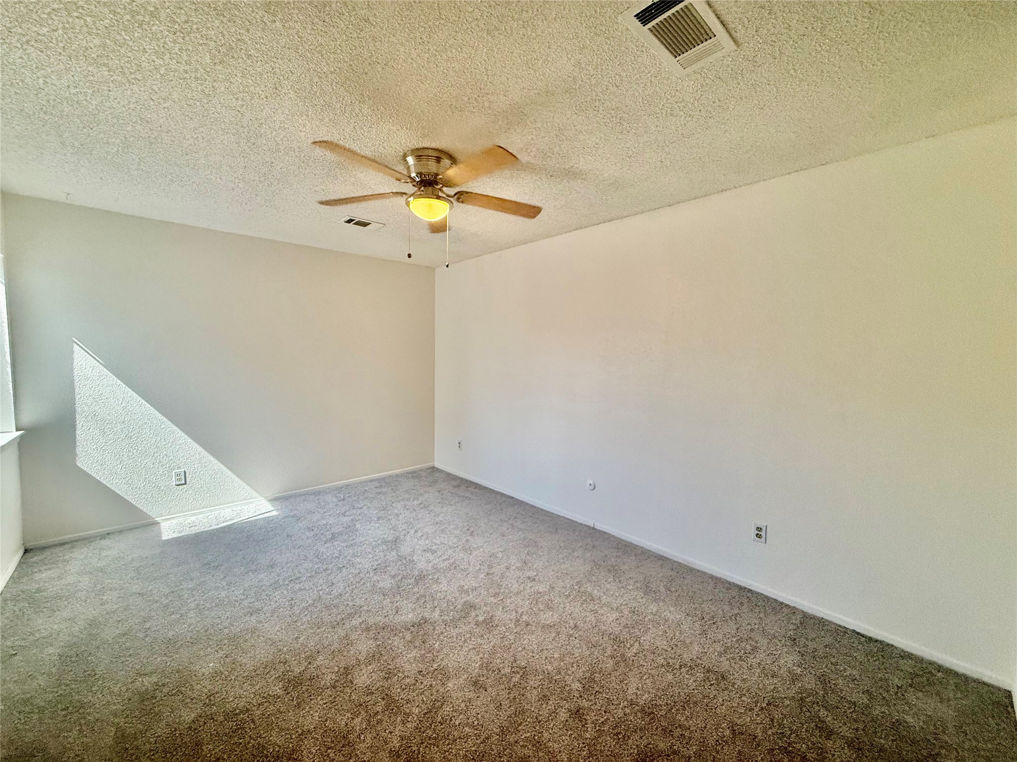 12922 Wirevine Lane Houston, TX 77072 - Photo 11 of 26 an empty room with a ceiling fan and carpet