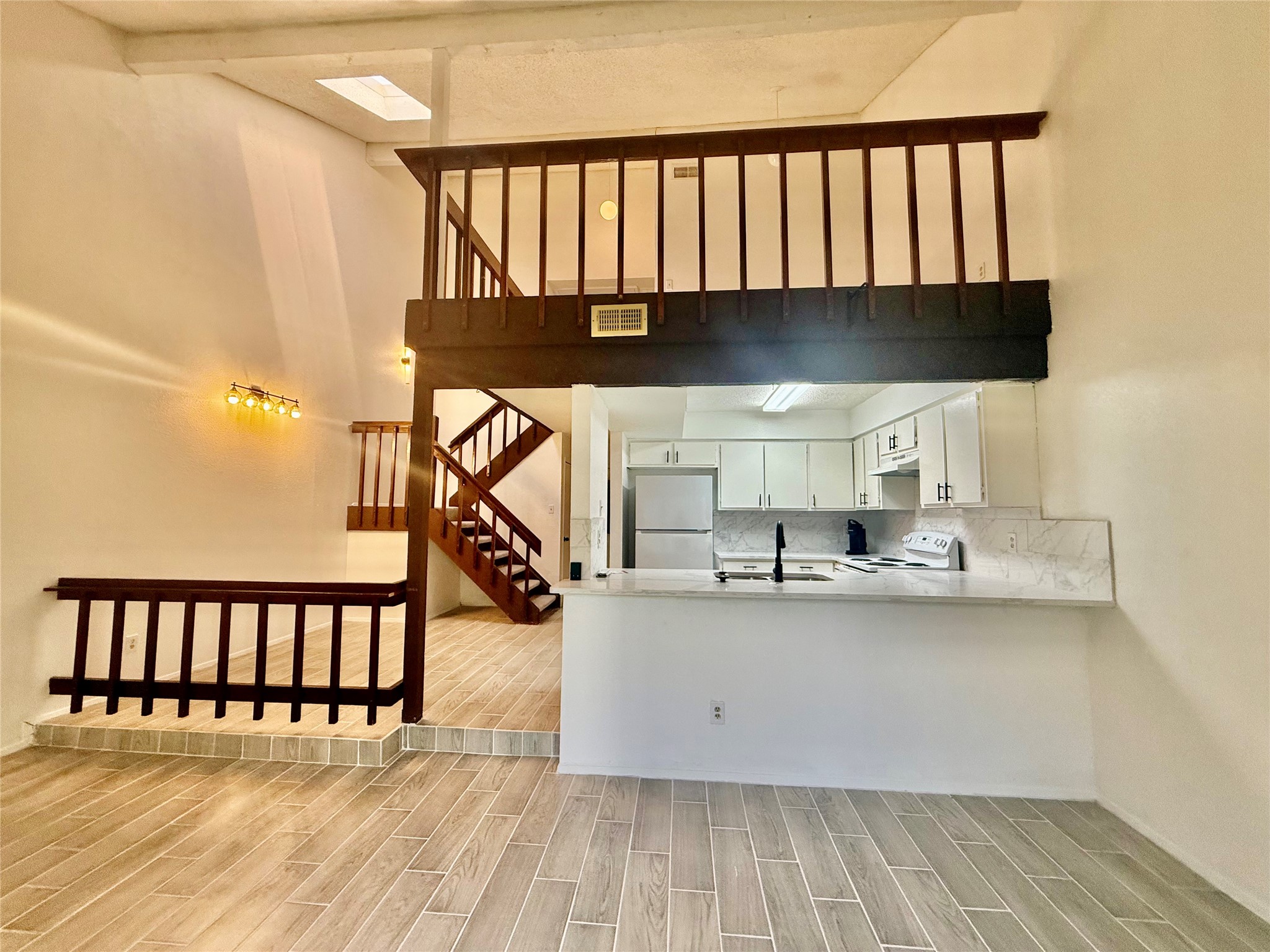 12922 Wirevine Lane Houston, TX 77072 - Photo 4 of 26 a view of a room with wooden floor and staircase