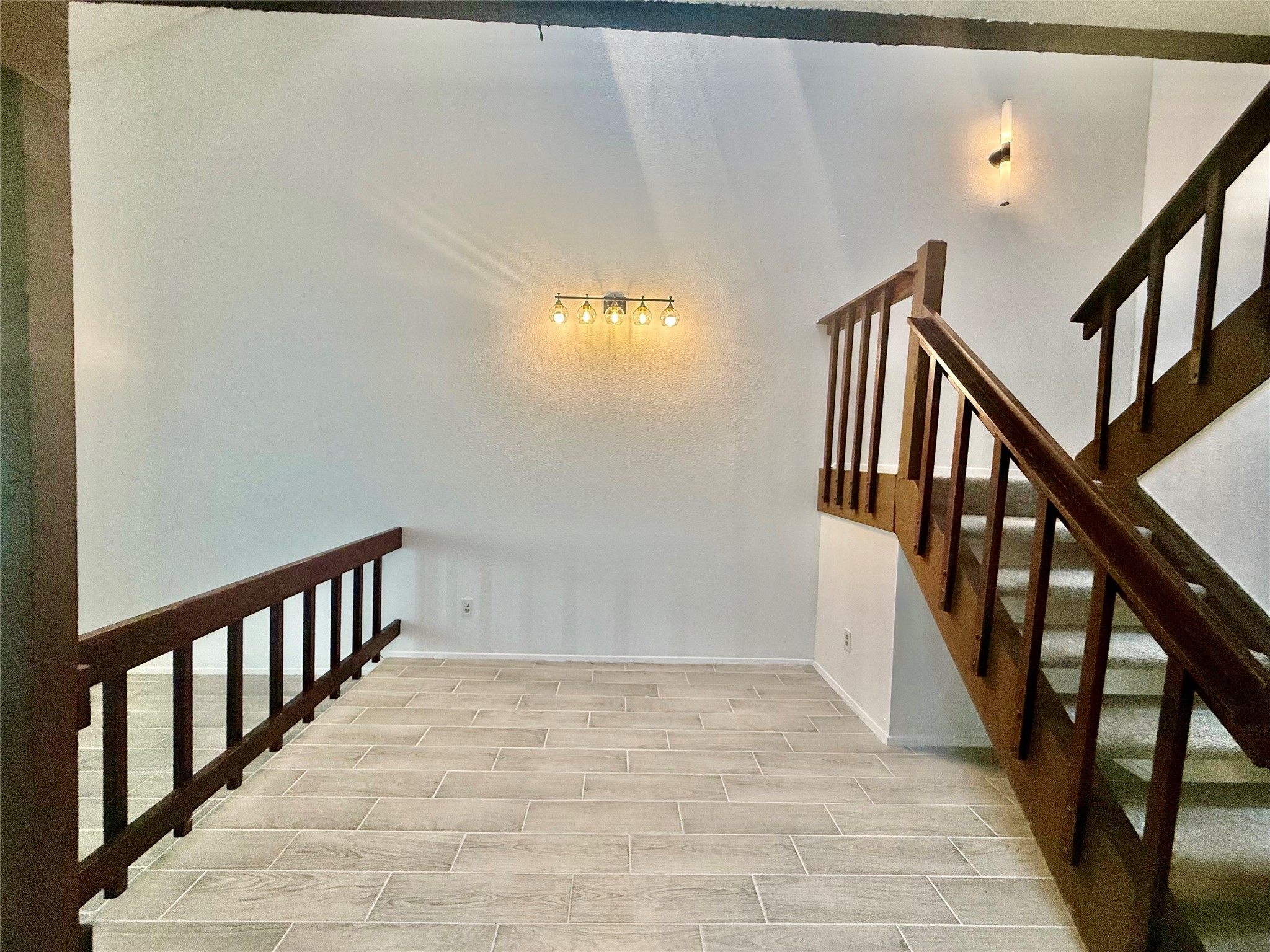 12922 Wirevine Lane Houston, TX 77072 - Photo 5 of 26 a view of staircase with lots of frames on wall and a window