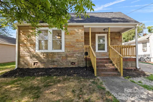 a view of a brick house with large windows