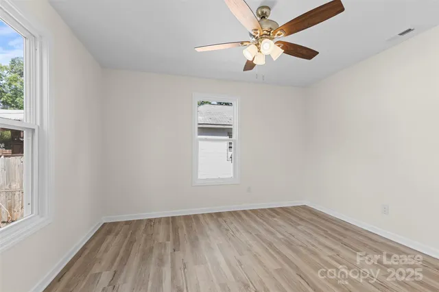 a bathroom with a granite countertop sink and a toilet