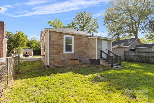 a view of backyard with garden and entertaining space