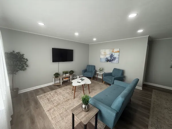 a living room with furniture and a flat screen tv