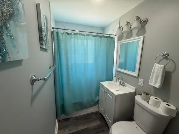 a bathroom with a toilet sink and mirror