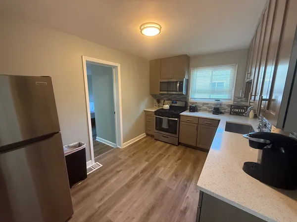 a kitchen with stainless steel appliances a refrigerator stove and sink