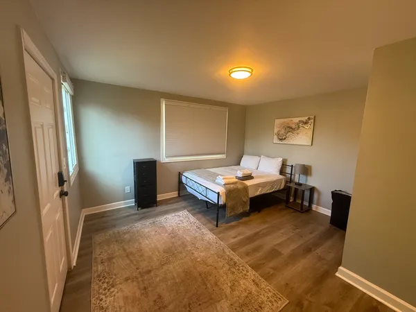 a spacious bedroom with a bed and a table in it