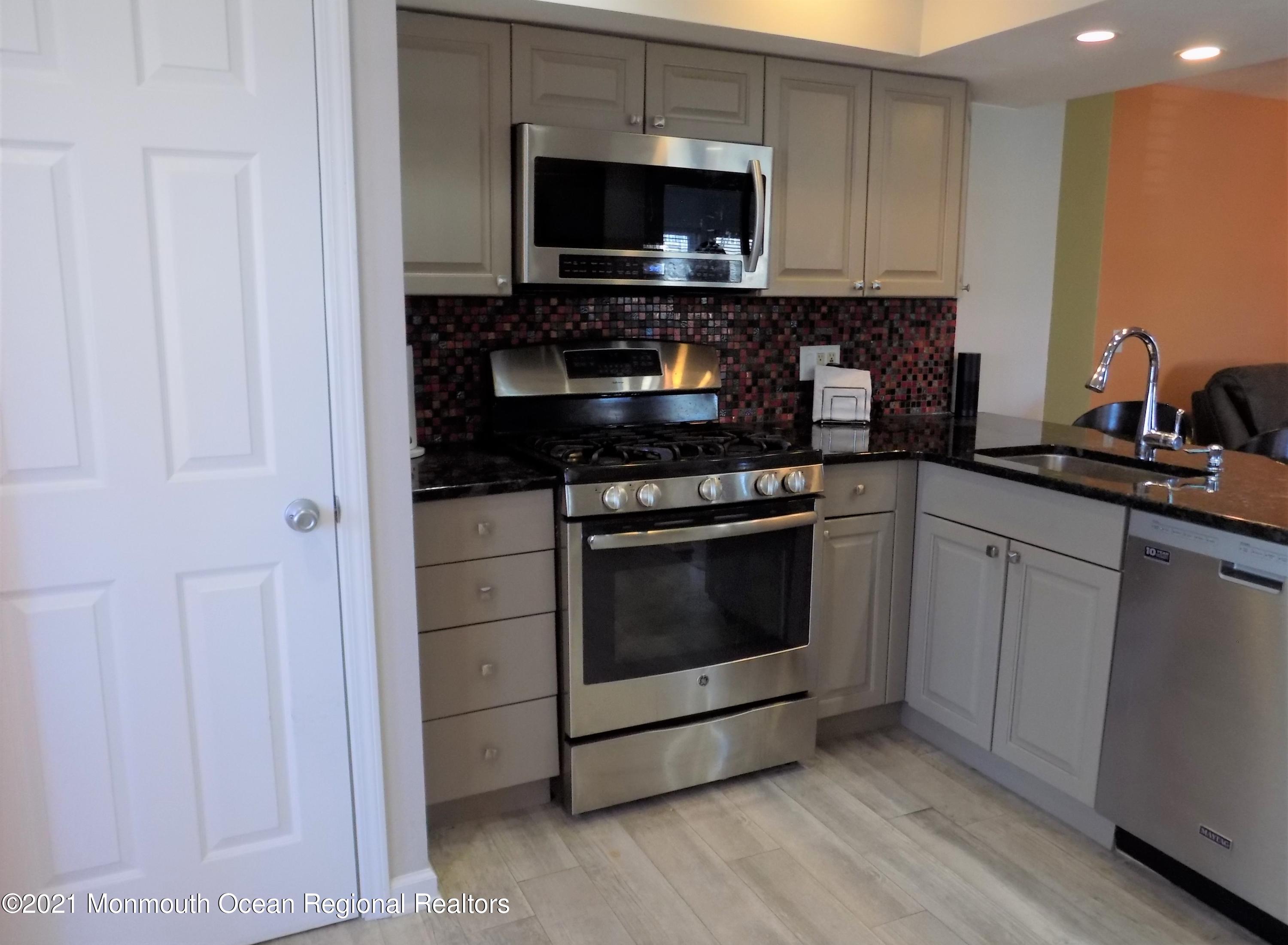 116 Gary Road Toms River, NJ 08753 - Photo 12 of 42 a kitchen with stainless steel appliances a stove microwave and sink