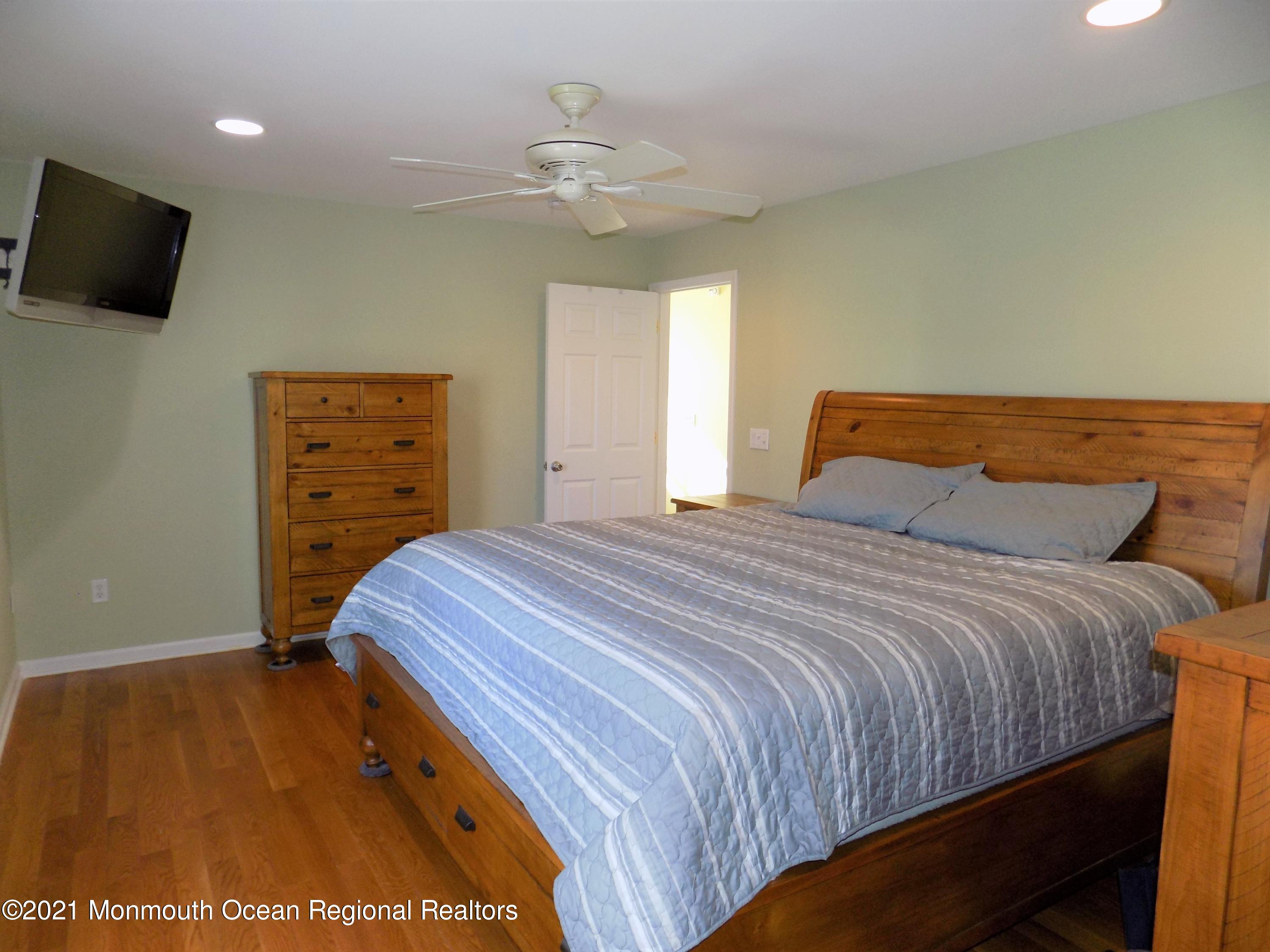 116 Gary Road Toms River, NJ 08753 - Photo 17 of 42 a bedroom with a bed and a flat tv screen on dresser