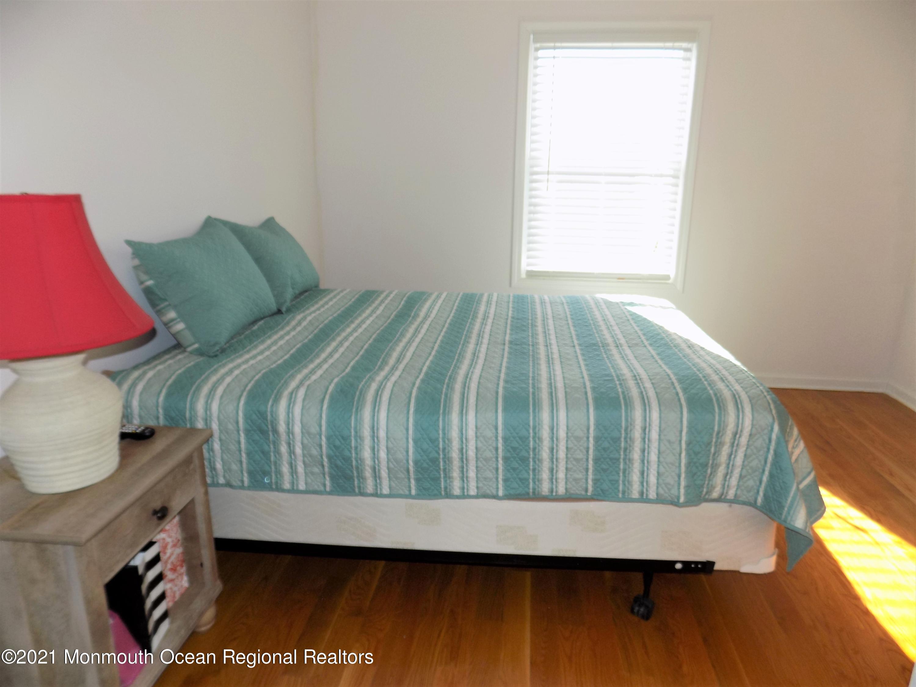 116 Gary Road Toms River, NJ 08753 - Photo 22 of 42 a bedroom with a bed and wooden floor