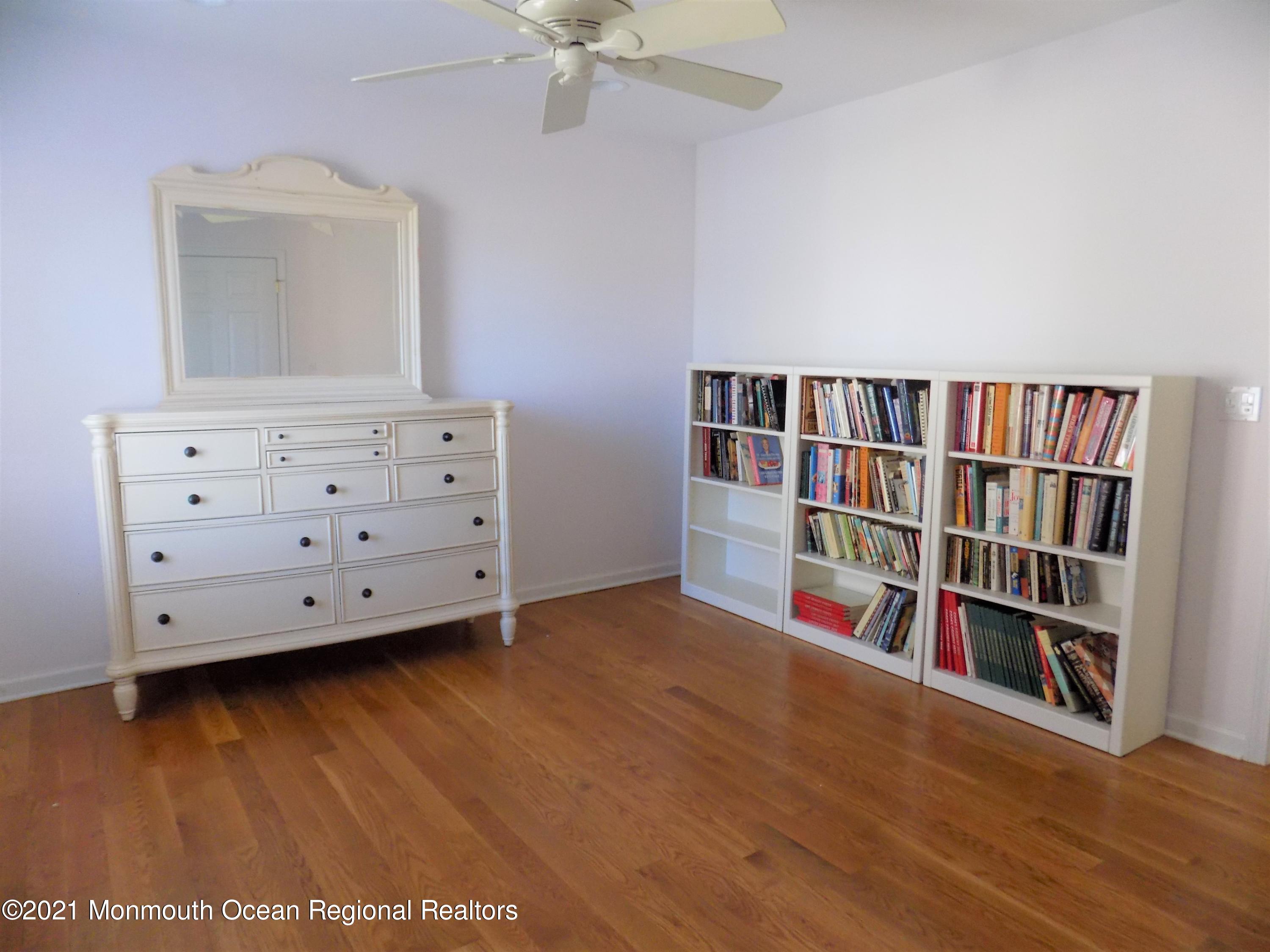116 Gary Road Toms River, NJ 08753 - Photo 23 of 42 a room with a book shelf and a wooden floor