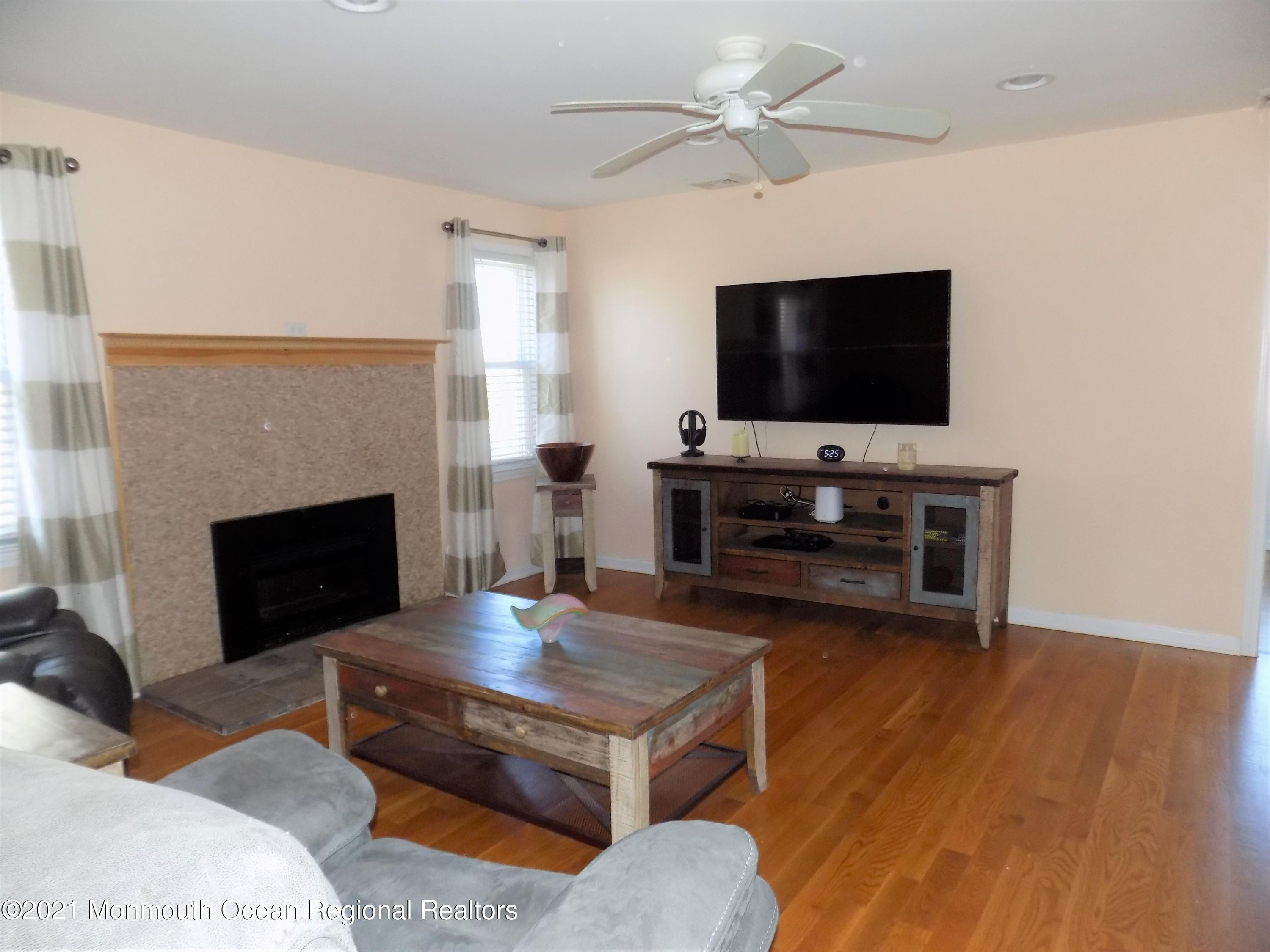 116 Gary Road Toms River, NJ 08753 - Photo 10 of 42 a living room with furniture a flat screen tv and a fireplace