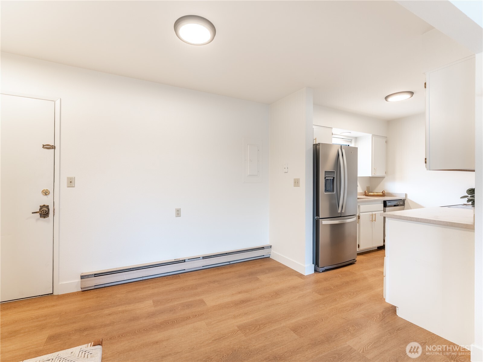 429 King Street, Unit 332 Wenatchee, WA 98801 - Photo 11 of 32 a view of a refrigerator in kitchen and white cabinets