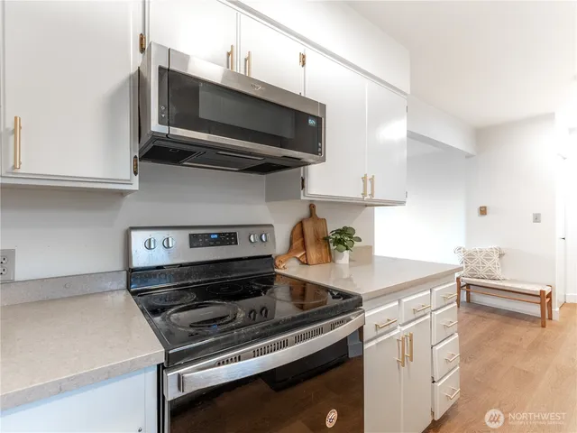 a kitchen with a stove and a microwave
