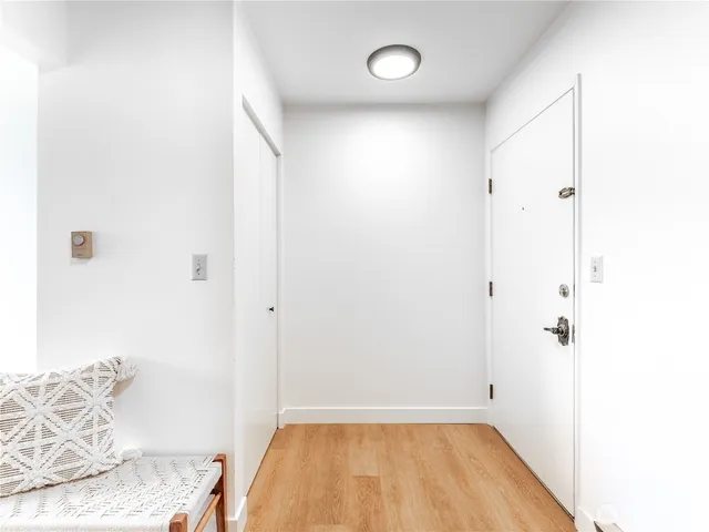 a view of a bedroom with wooden floor and closet