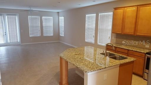 7652 Ripplepointe Way Windermere, FL 34786 - Photo 2 of 21 a kitchen with granite countertop sink and window