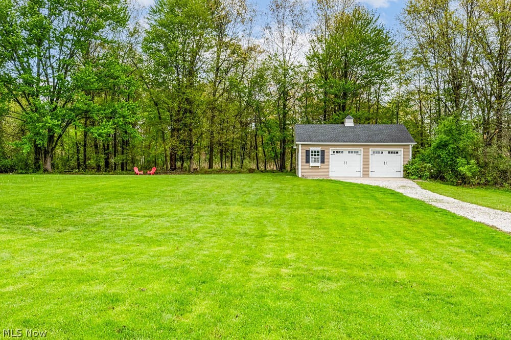 6787 South Palmyra Road Canfield, OH 44406 - Photo 28 of 30 Spacious grounds featuring a detached two-car garage with white paneled doors and a cupola accent