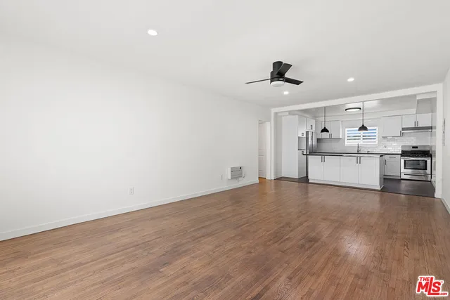 a view of a kitchen with a sink and wooden floor